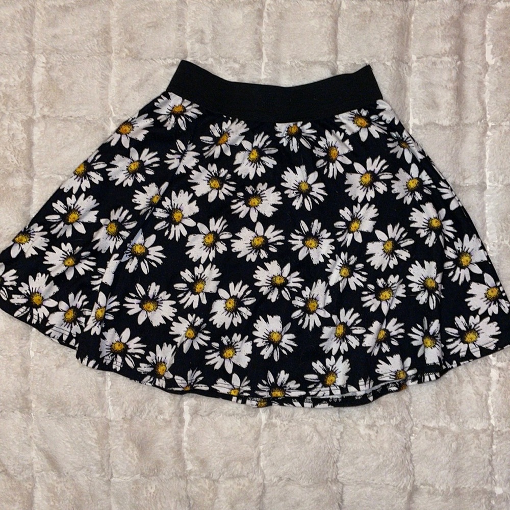 Daisy skater skirt with black background, great for unique outfits!